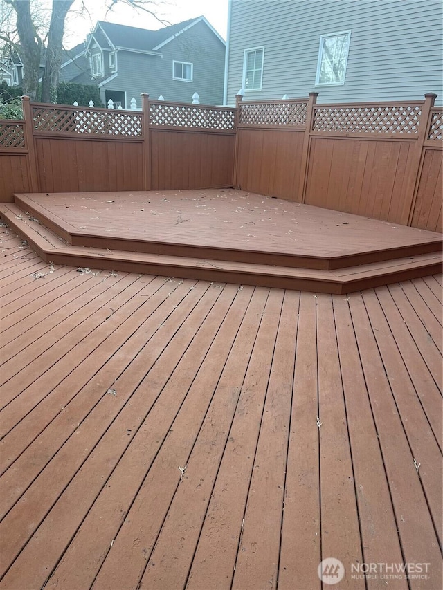 wooden terrace featuring fence