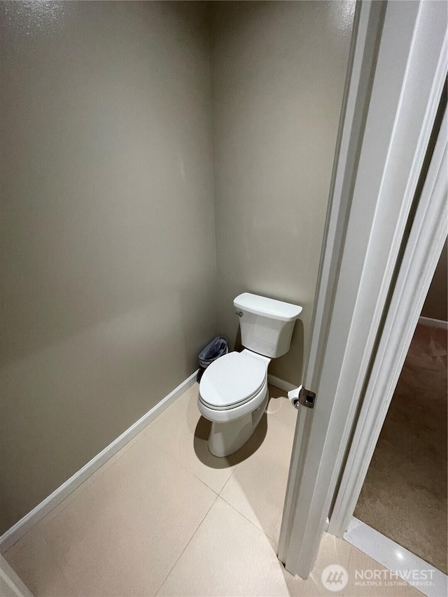 bathroom featuring baseboards and toilet