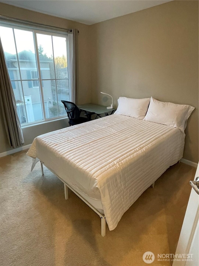 bedroom featuring carpet flooring and baseboards