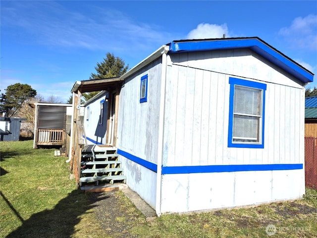 view of side of home featuring a lawn