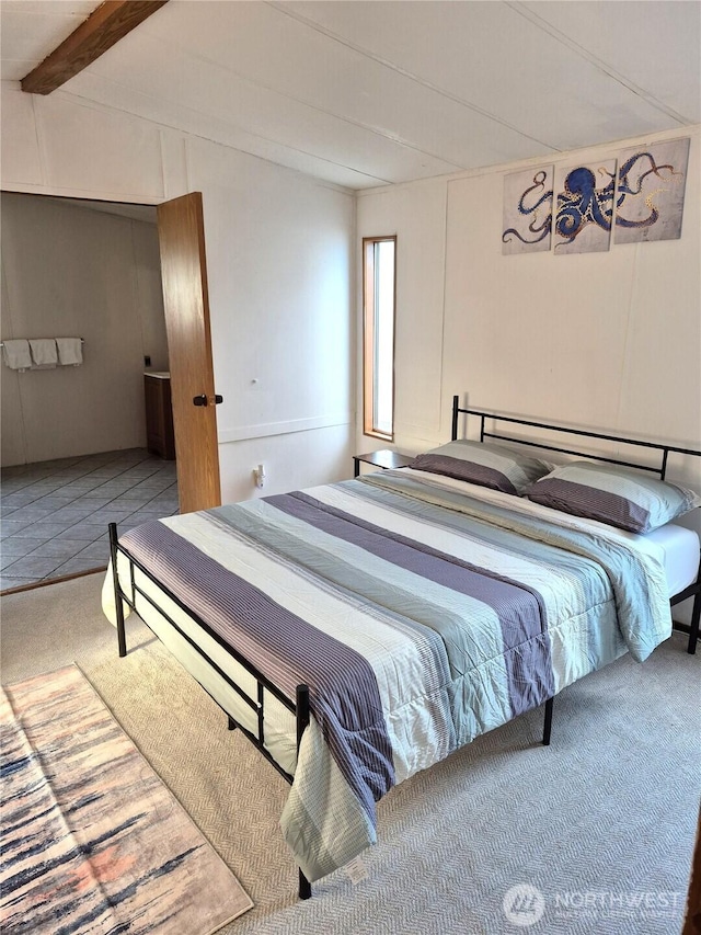 carpeted bedroom with lofted ceiling with beams and tile patterned floors