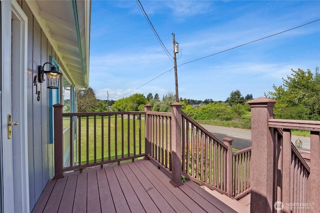 wooden deck with a lawn