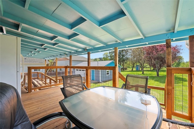 wooden deck with a yard and outdoor dining space