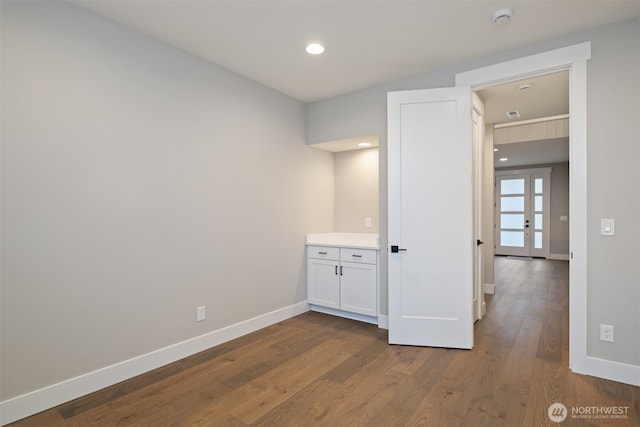 unfurnished room with dark wood-style floors, recessed lighting, and baseboards