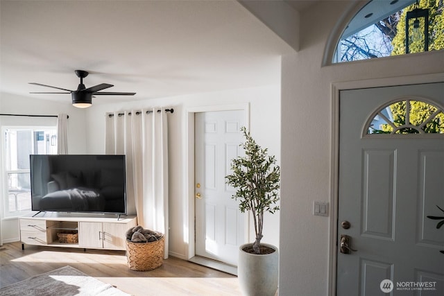 entrance foyer with wood finished floors and a ceiling fan