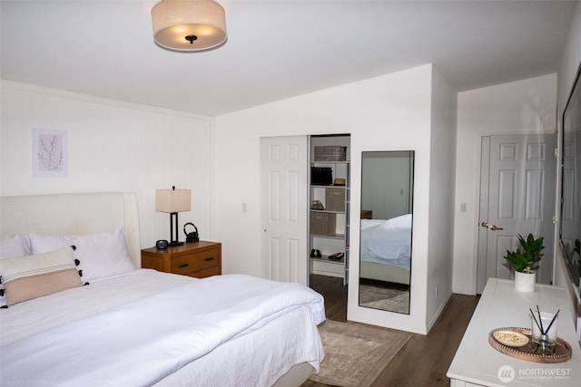 bedroom featuring vaulted ceiling, a closet, and wood finished floors