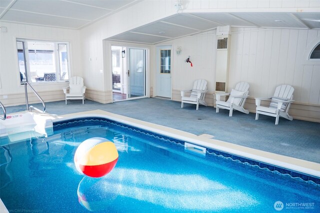 view of swimming pool with a hot tub