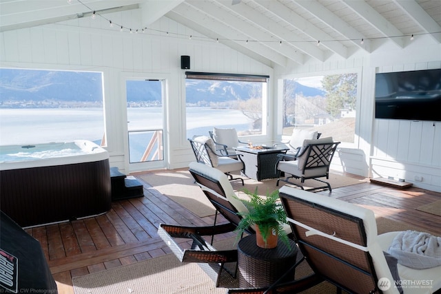 sunroom / solarium with vaulted ceiling with beams