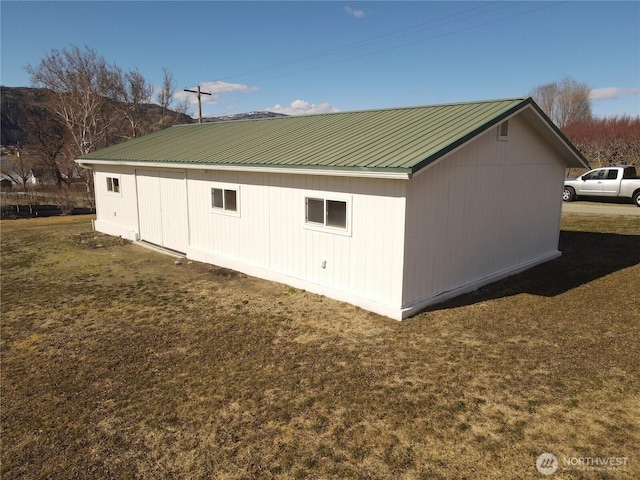 view of home's exterior featuring metal roof and a yard