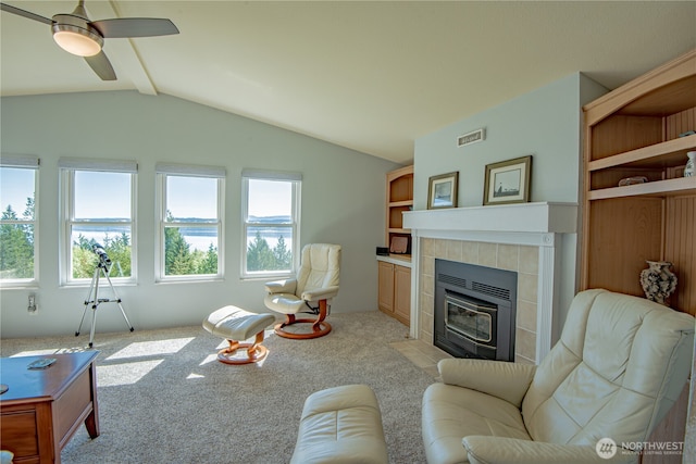 living room featuring visible vents, plenty of natural light, lofted ceiling with beams, and a water view