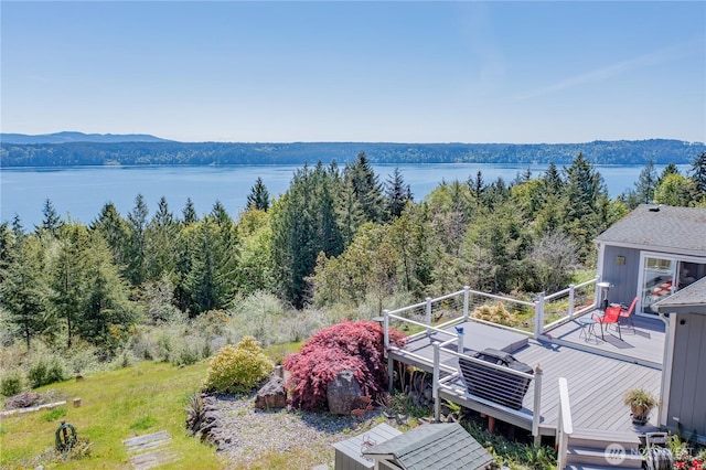 birds eye view of property featuring a water view and a view of trees