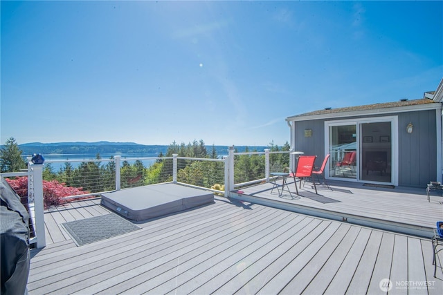 deck with a water and mountain view