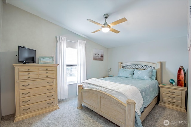 bedroom featuring lofted ceiling, ceiling fan, and light colored carpet