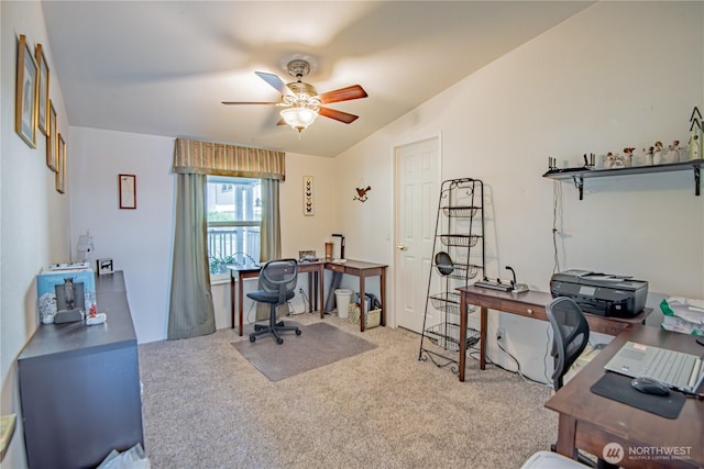 carpeted home office featuring a ceiling fan and lofted ceiling