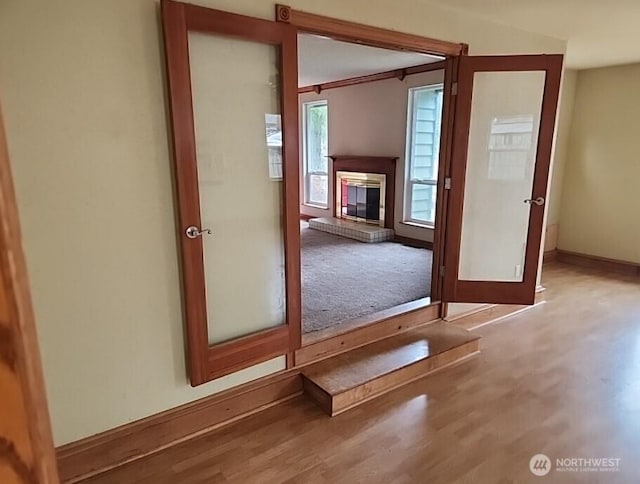 interior space with baseboards and wood finished floors