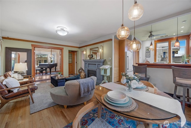 dining room with wood finished floors and a fireplace