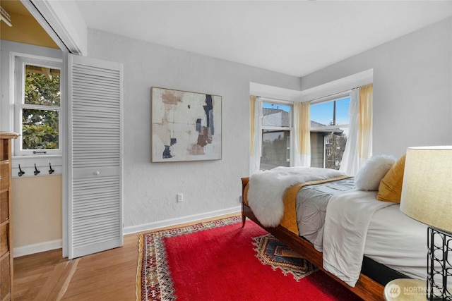 bedroom featuring light wood-style flooring and baseboards