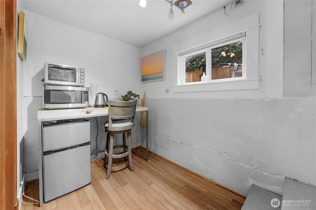 office area featuring a toaster and wood finished floors