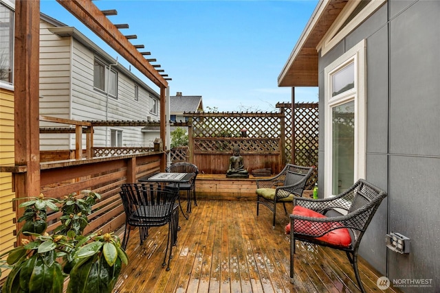 wooden deck with a pergola and fence