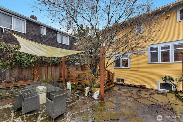 view of patio featuring outdoor dining space and fence