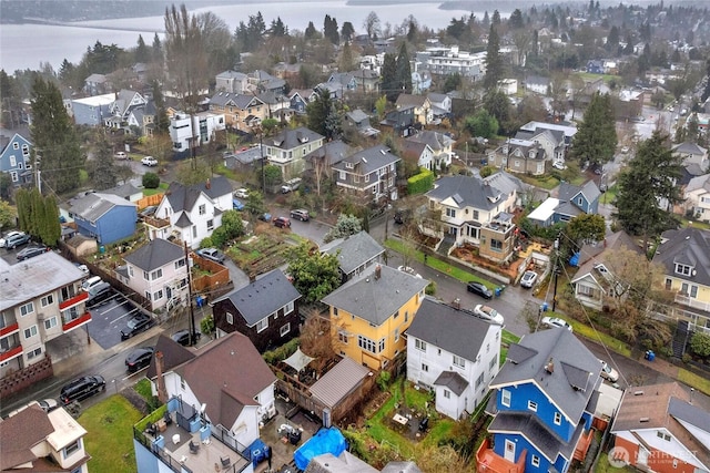 birds eye view of property with a residential view and a water view