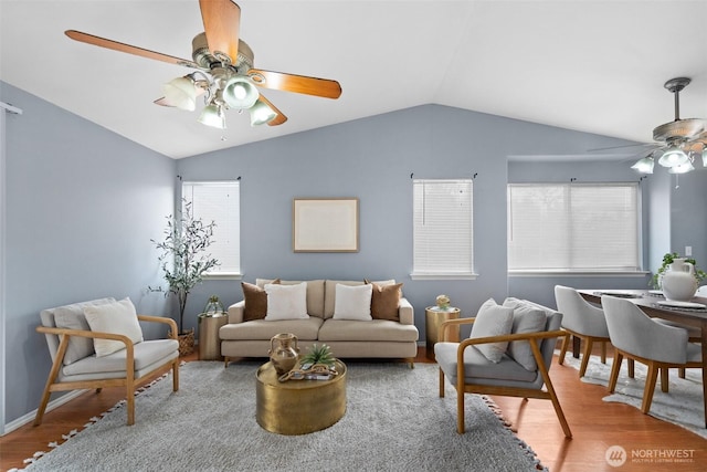 living room with a ceiling fan, lofted ceiling, wood finished floors, and baseboards