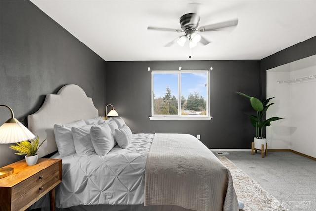 carpeted bedroom with baseboards and ceiling fan