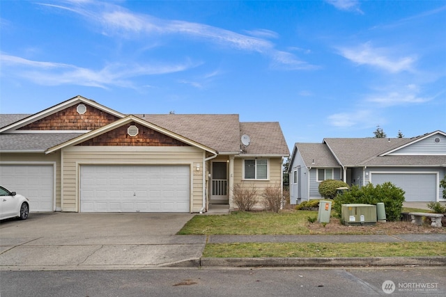 view of front facade with concrete driveway, a garage, and roof with shingles