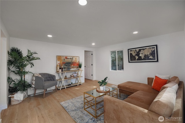 living area featuring recessed lighting, baseboards, and wood finished floors