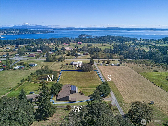 birds eye view of property featuring a water and mountain view