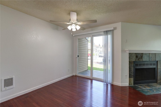 unfurnished living room featuring a healthy amount of sunlight, wood-type flooring, a fireplace, and baseboards