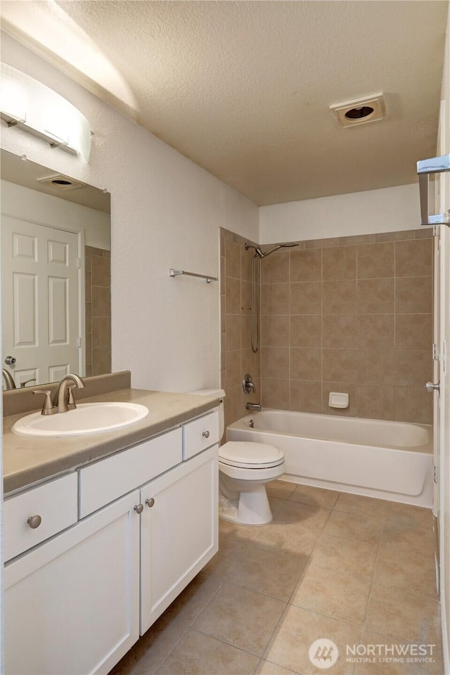 full bath with shower / bathtub combination, toilet, vanity, a textured ceiling, and tile patterned flooring