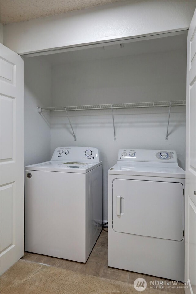 washroom with laundry area and washer and clothes dryer