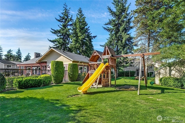 view of jungle gym featuring a lawn and fence