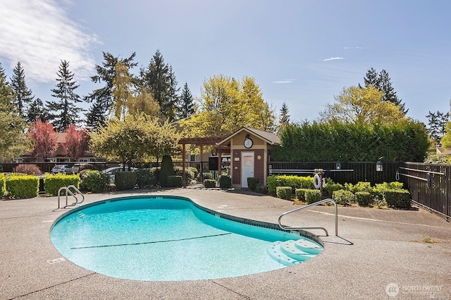 pool with a patio area and fence