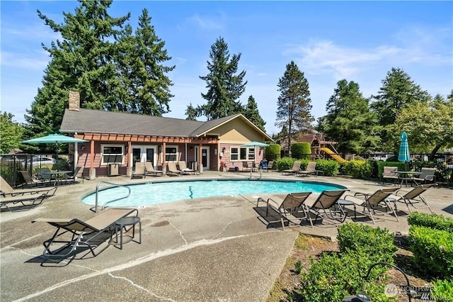 pool featuring a patio area and fence