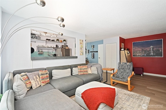 living room with baseboards and wood finished floors