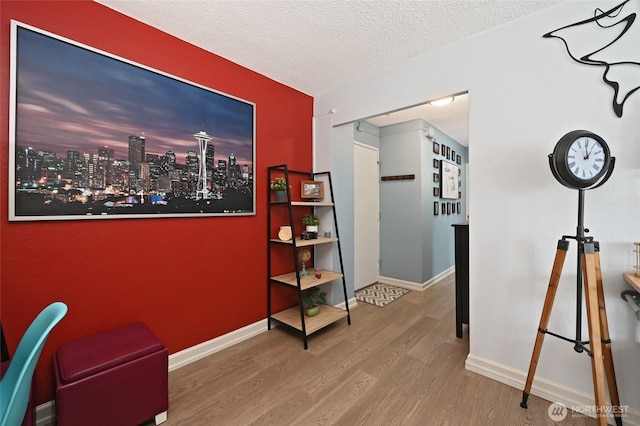 office space with wood finished floors, baseboards, and a textured ceiling