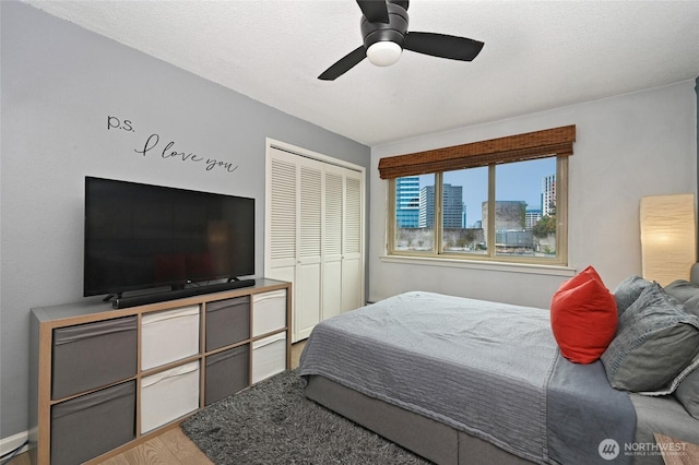 bedroom with a closet, ceiling fan, and wood finished floors