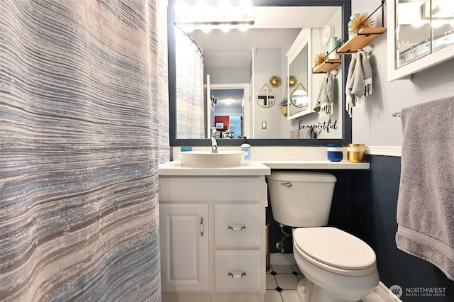 bathroom featuring toilet and vanity