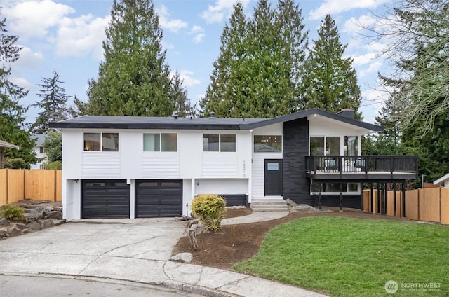 view of front facade featuring concrete driveway, an attached garage, a front yard, entry steps, and fence