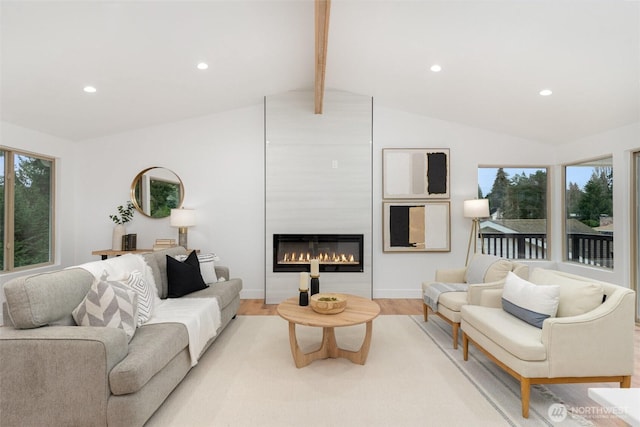 living area with light wood-style flooring, recessed lighting, a large fireplace, and lofted ceiling with beams