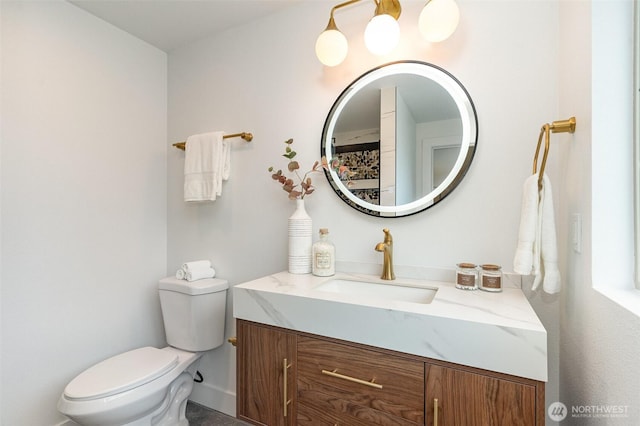 bathroom featuring vanity and toilet