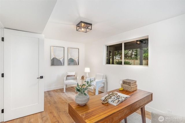 home office with baseboards and light wood-style floors