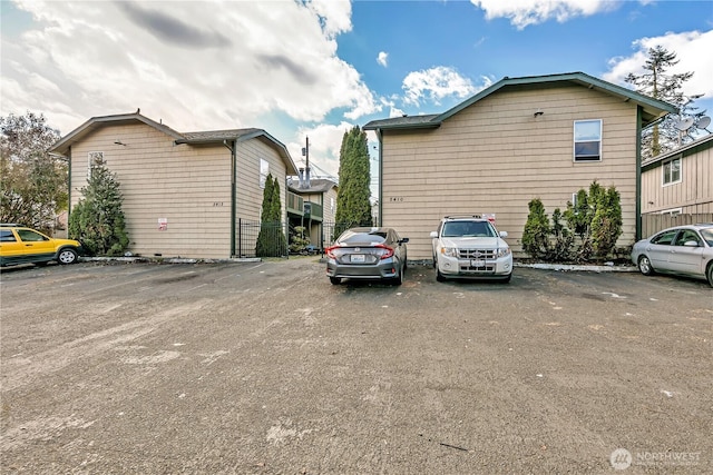 view of side of home with uncovered parking