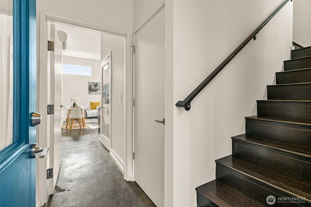 staircase with concrete flooring