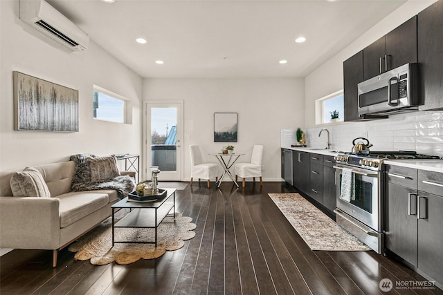 living room with recessed lighting, dark wood-style flooring, and a wall mounted air conditioner