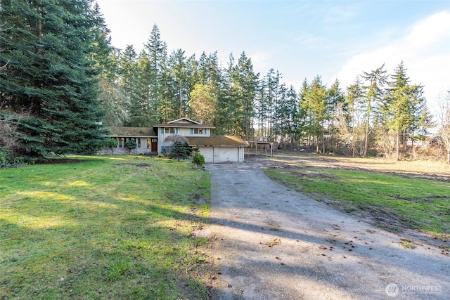 view of front of property featuring a garage and a front yard