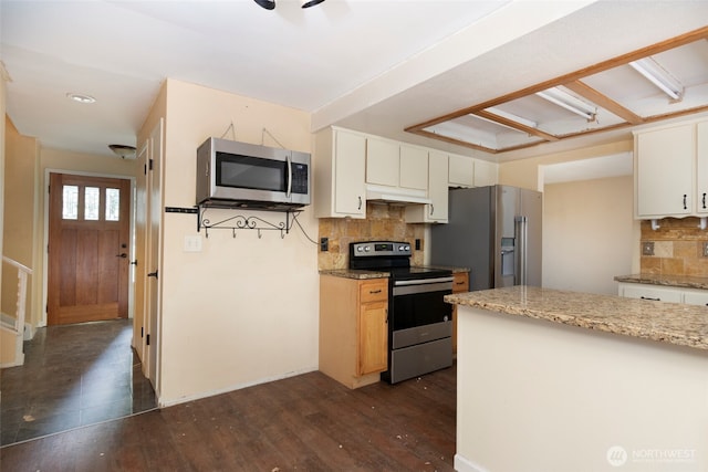 kitchen featuring decorative backsplash, dark wood-style flooring, stainless steel appliances, under cabinet range hood, and white cabinetry