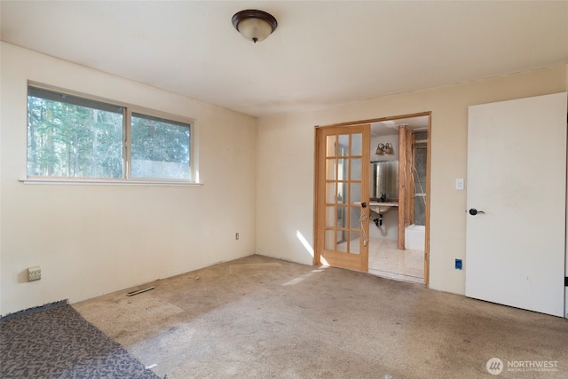 carpeted spare room with a sink